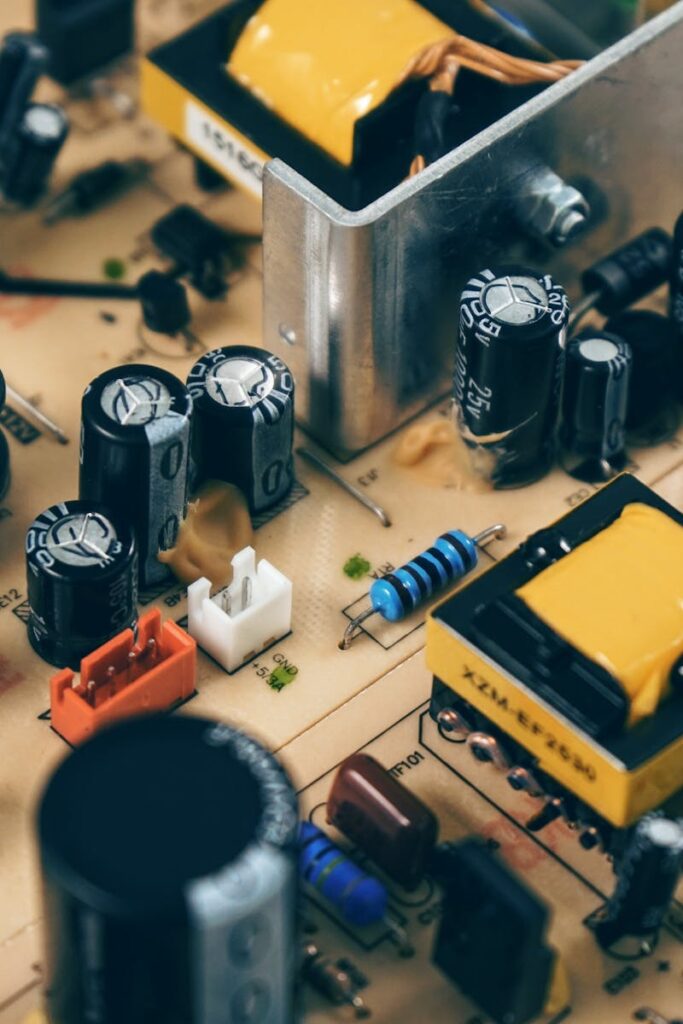 Detailed shot of capacitors and resistors on a circuit board, showcasing modern technology.